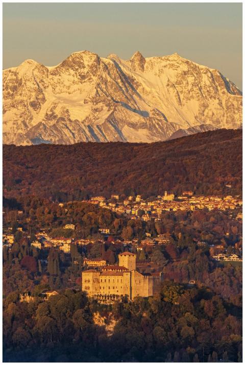 Beautiful castle with snowy mountains and autumn f