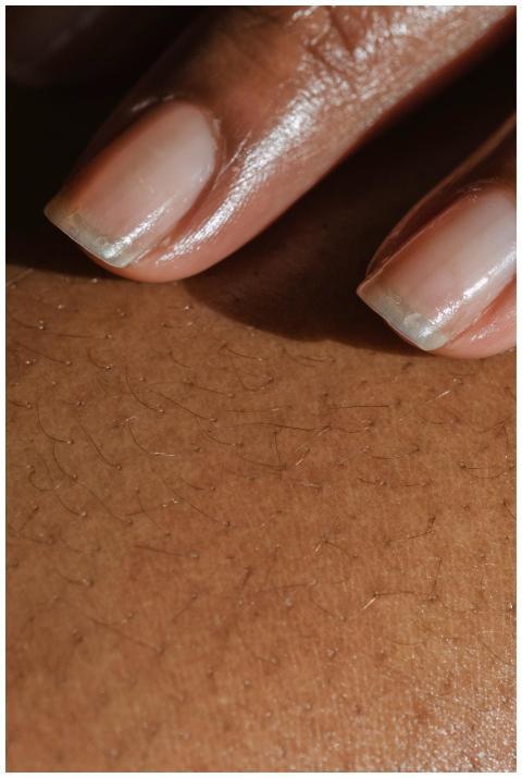 Detailed close-up of fingers touching skin, showca