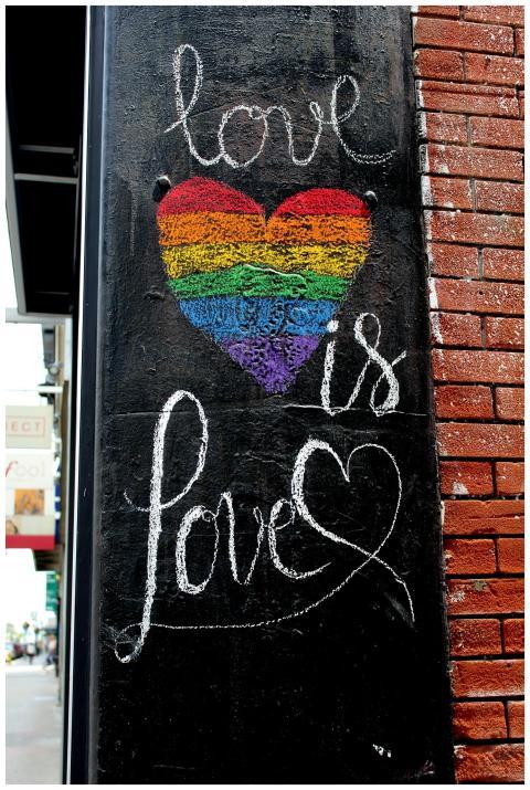 Colorful street art featuring a rainbow heart and