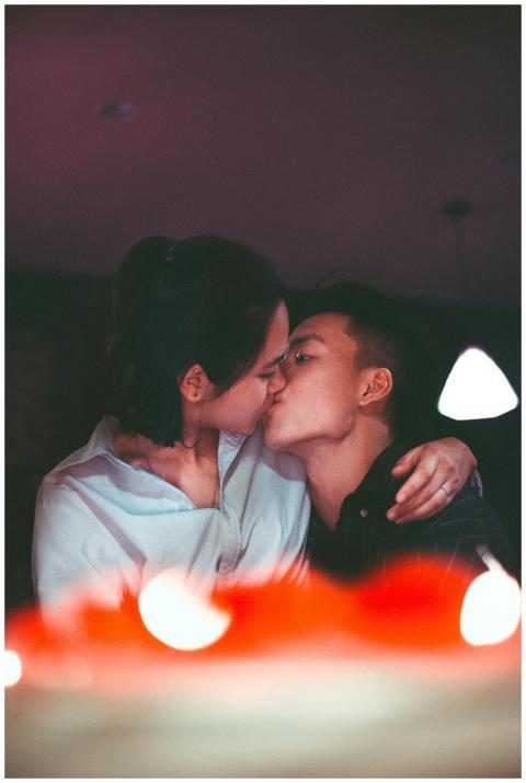 A romantic kiss shared by an Asian couple, capture