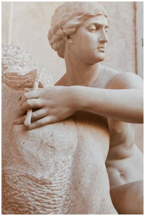 A finely detailed classical Greek statue showcasin