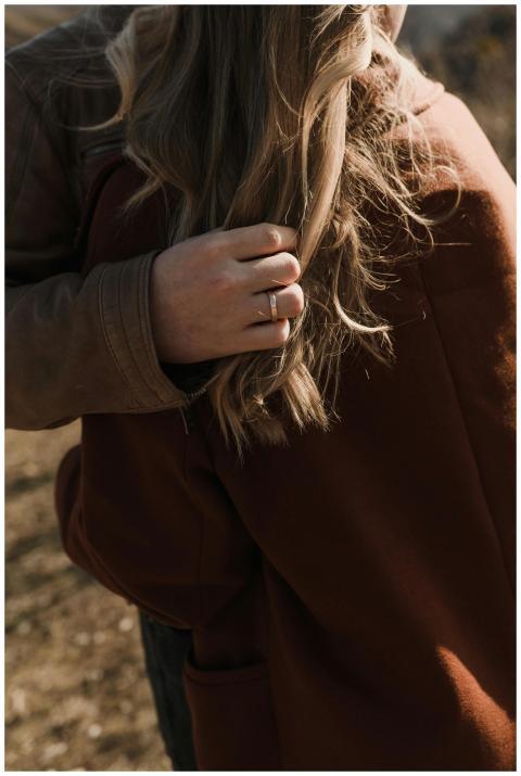 Close-up of a couple's embrace showing engagement