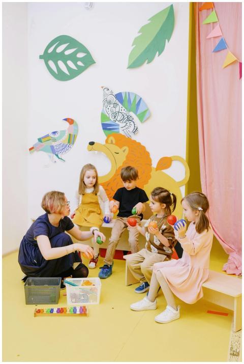 Colorful preschool classroom with teacher and chil