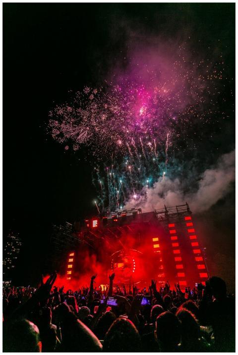 Energetic outdoor concert at night with a vibrant
