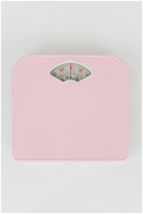 Modern pink bathroom scale on white background, mi