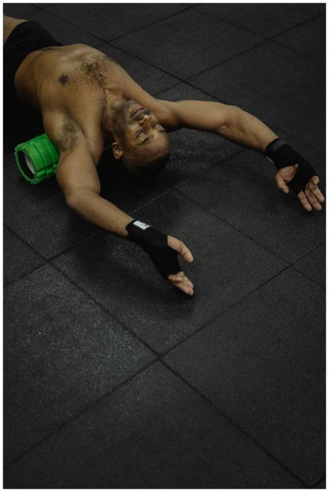 Shirtless African American man using a green foam