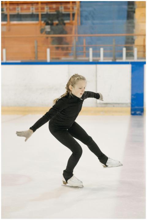 Young girl gracefully figure skating on an indoor