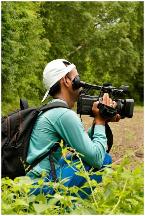 A man films nature outdoors in Sanand, Gujarat, hi