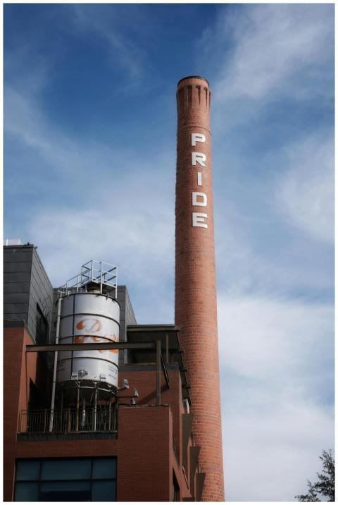 Red brick chimney with 'Pride' text towers against