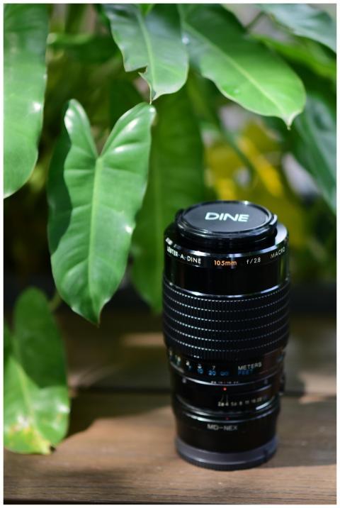 Close-up of a macro lens placed on a wooden surfac