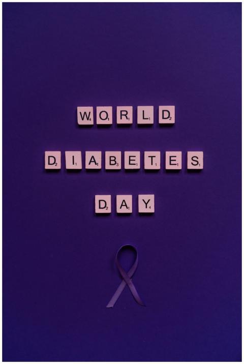 Purple-themed image with scrabble tiles spelling W