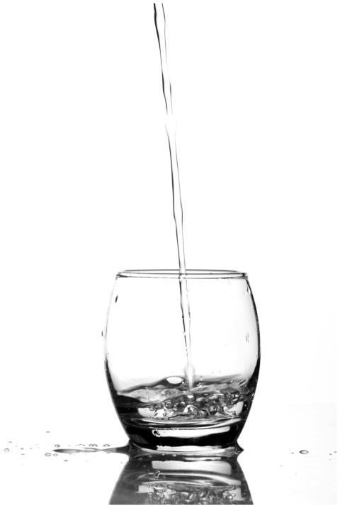 Refreshing image of water being poured into a glas