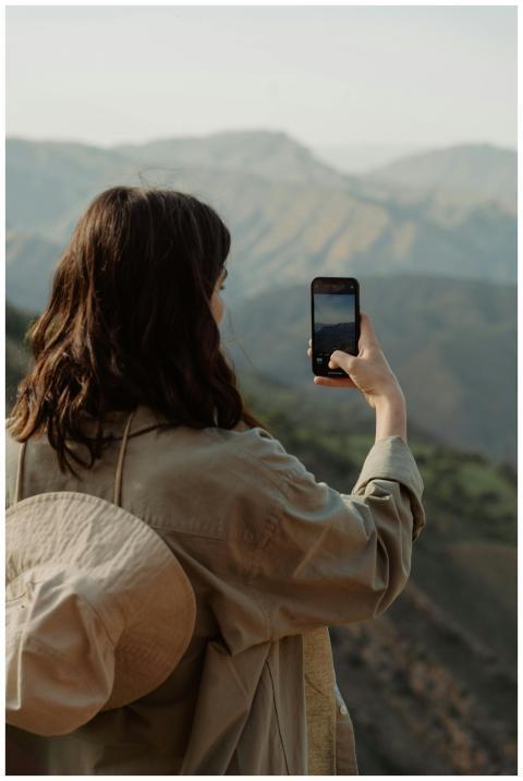 Woman taking a photo with smartphone, capturing be