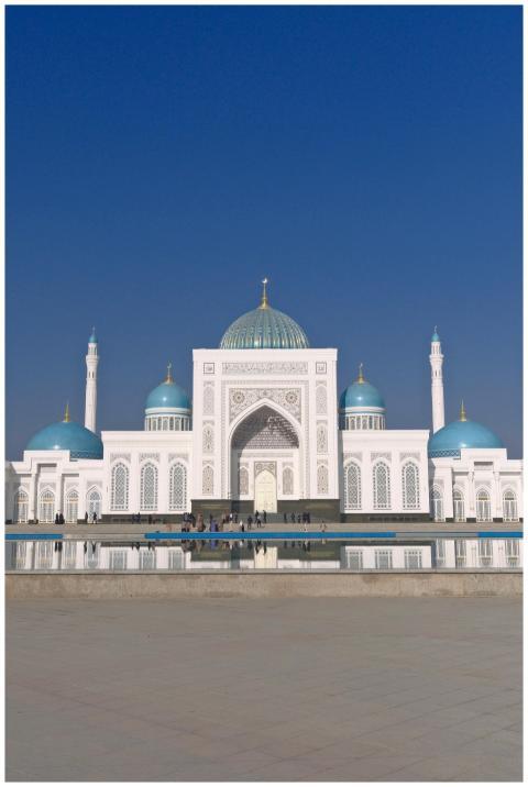 Beautiful white and blue domed mosque under a clea
