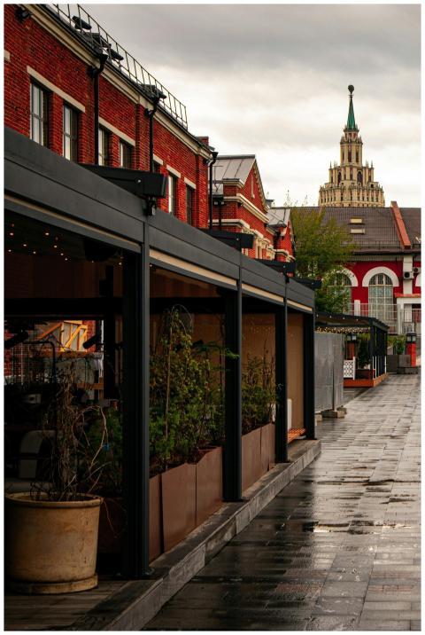 A rainy street scene in Moscow featuring a histori