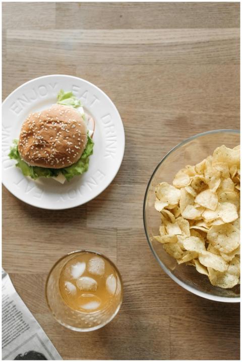 A bird's-eye view of a burger, chips, and a drink