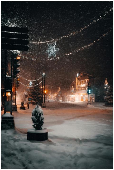 A picturesque snowy town square at night with Chri