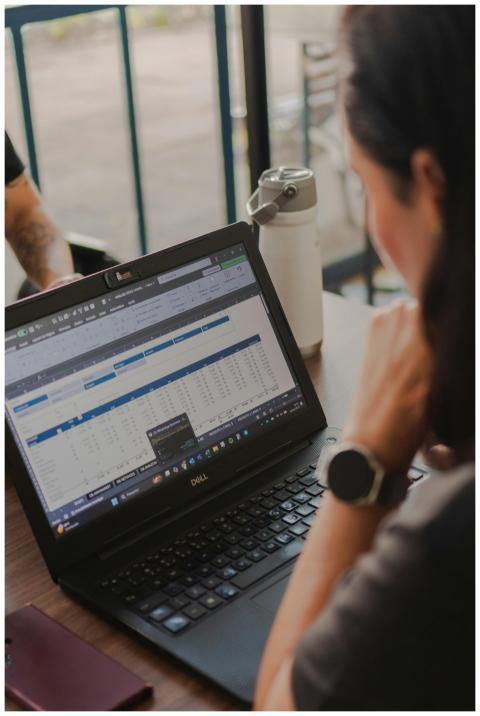 Close-up of a person reviewing a spreadsheet on a