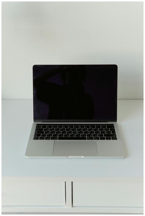 A modern laptop with a blank screen on a minimalis