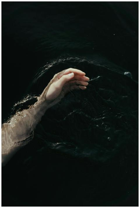 A serene hand gracefully touching the dark, myster