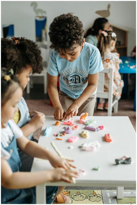 Young kids enjoy crafting with colorful clay in a