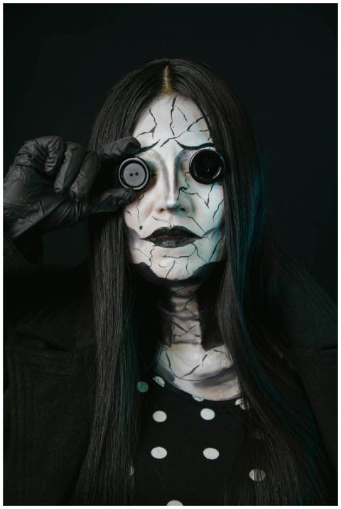 A haunting figure with cracked face paint and butt