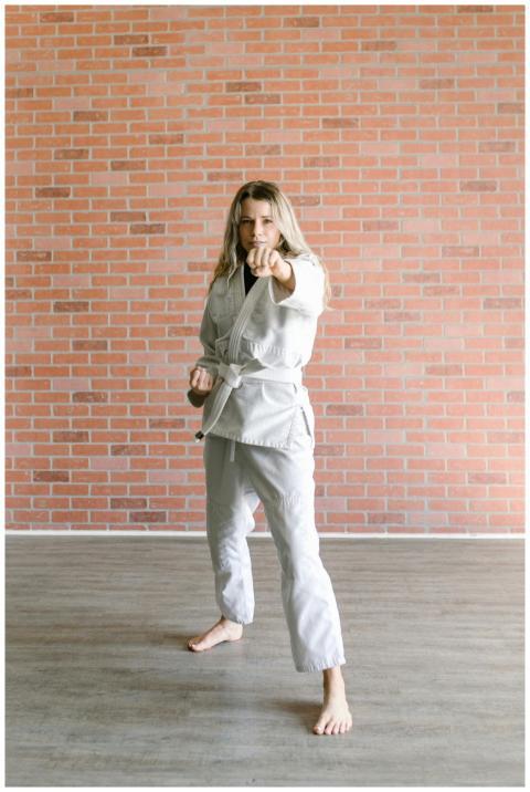 Woman in white martial arts uniform practicing tae