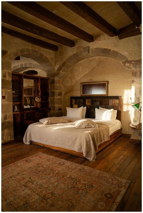 Warm and inviting luxury bedroom with stone walls