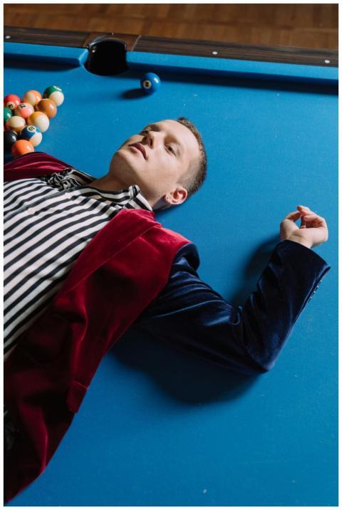 A fashionable man in a striped shirt and velvet ja