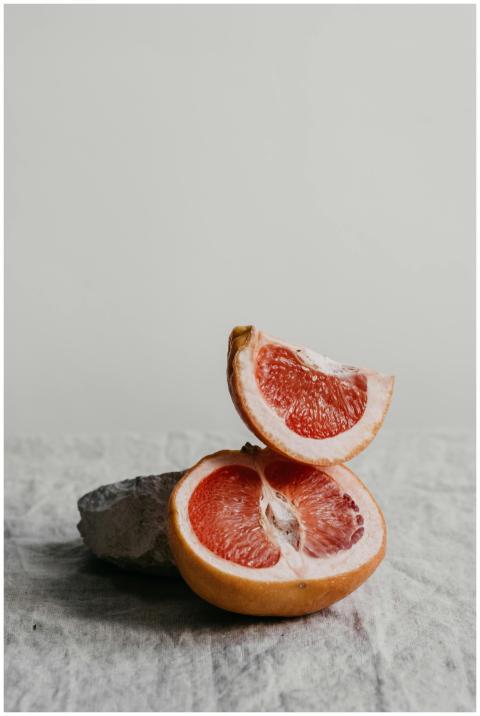 Juicy grapefruit slices on linen, highlighting its