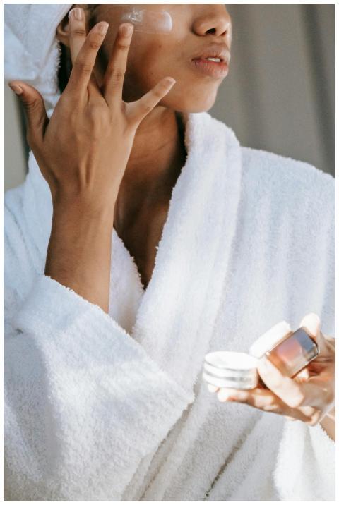 Crop unrecognizable  young female in white bathrob