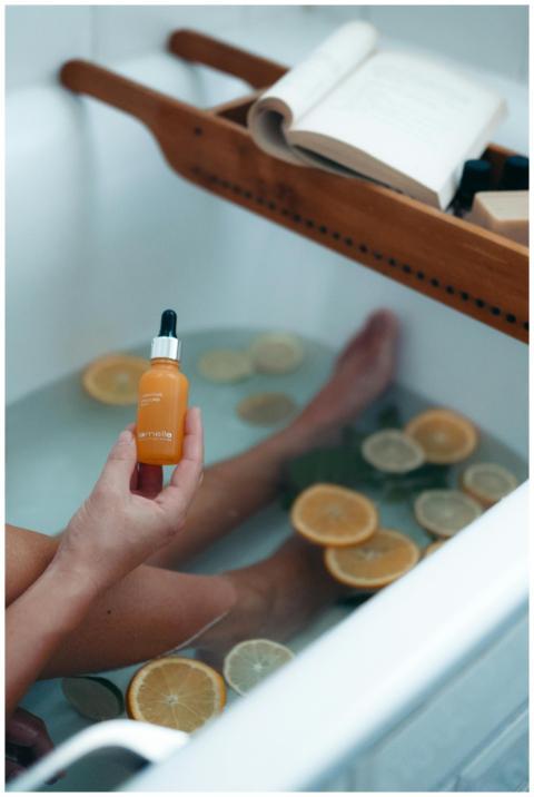 Serene bath scene featuring citrus fruits and a be