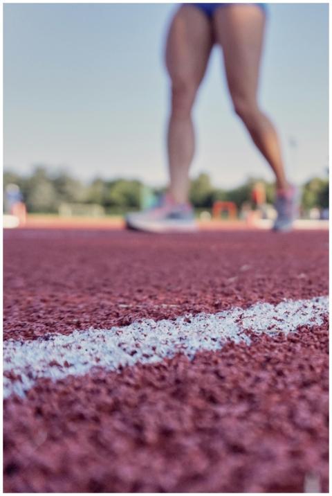 Closeup view of athlete's legs standing on outdoor