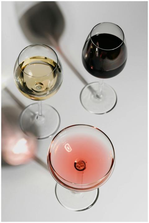 Three glasses with red, white, and rosé wine on a