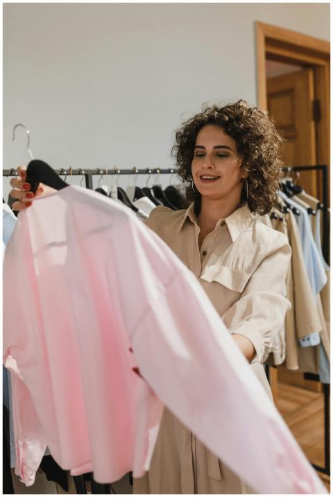 Smiling woman shopping in a fashion store holding