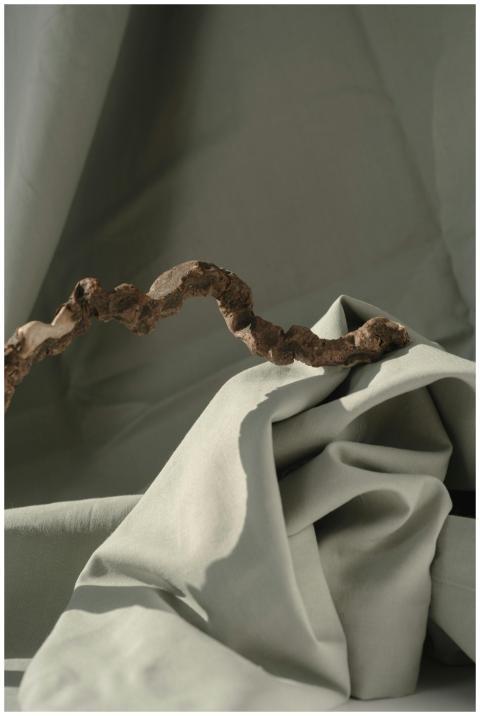 Minimalist still life of fabric with a twisted woo
