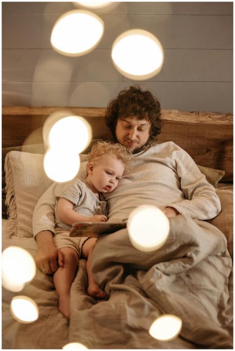 A father and child enjoy a bedtime story in a warm