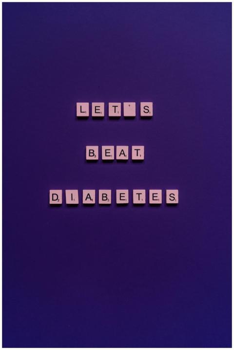 Scrabble tiles on a purple background spell out 'L