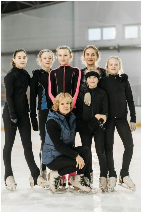 A group of young figure skaters posing with their