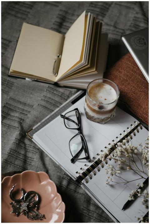 A warm and cozy home workspace featuring a noteboo