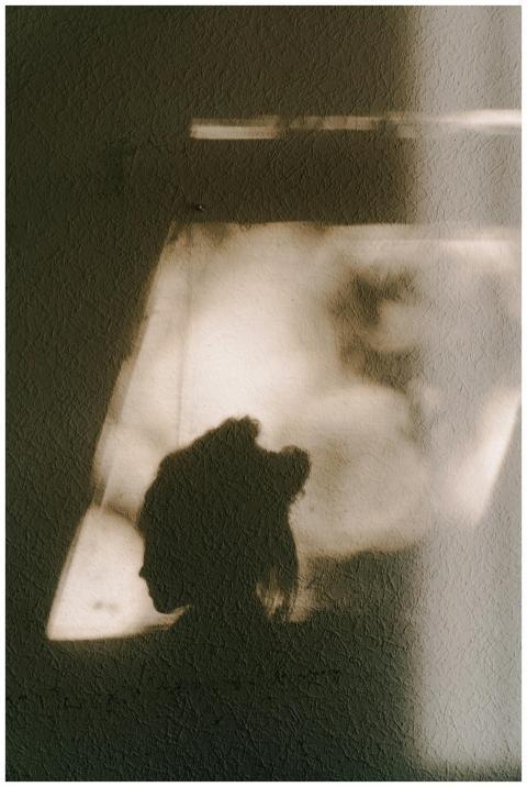 Silhouette of a person cast as a shadow on a textu