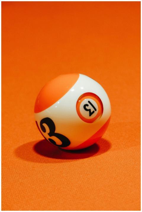 Billiard ball with number on bright orange surface