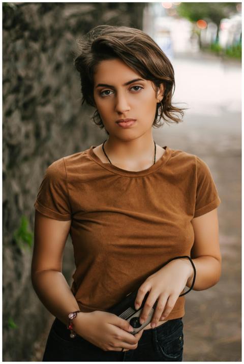 Portrait of a fashionable young woman standing out