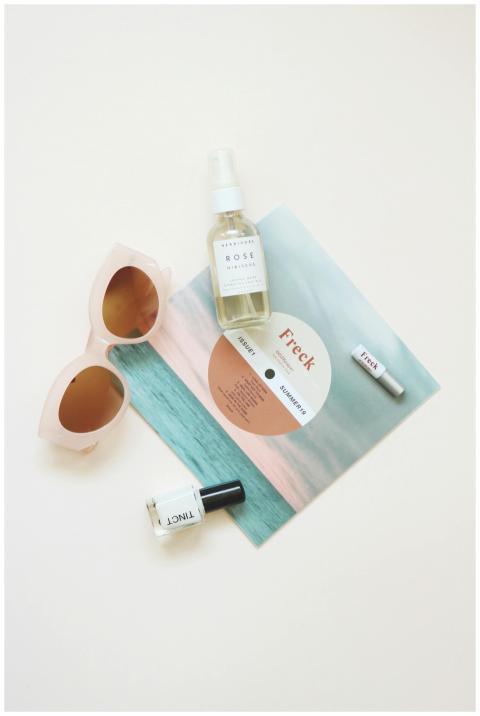High-angle flatlay of summer essentials including