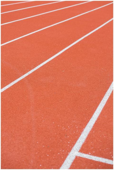 Detailed view of athletic track surface with white