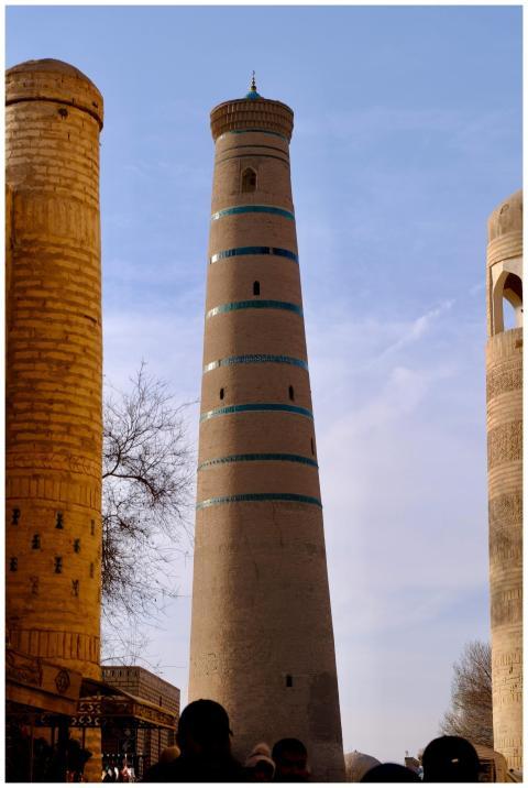 A tall minaret in Khiva, Uzbekistan, showcasing an