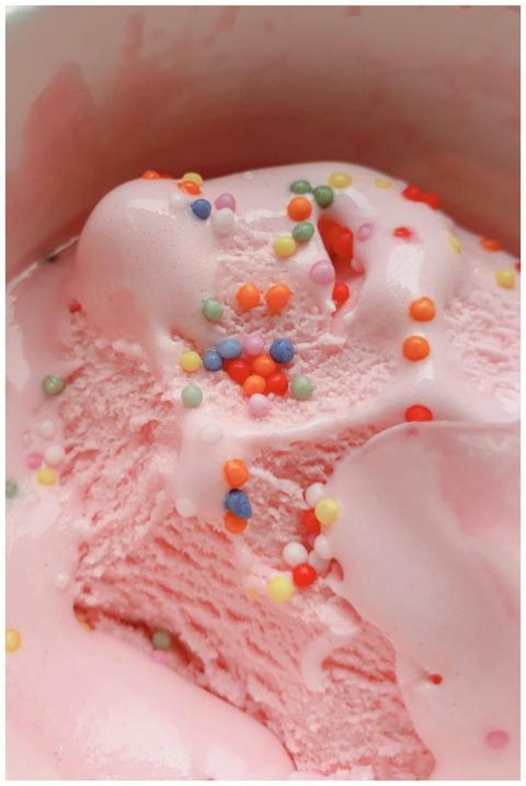 Delicious pink ice cream topped with colorful spri