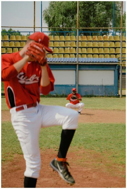 Pitcher throwing a baseball with a catcher in posi