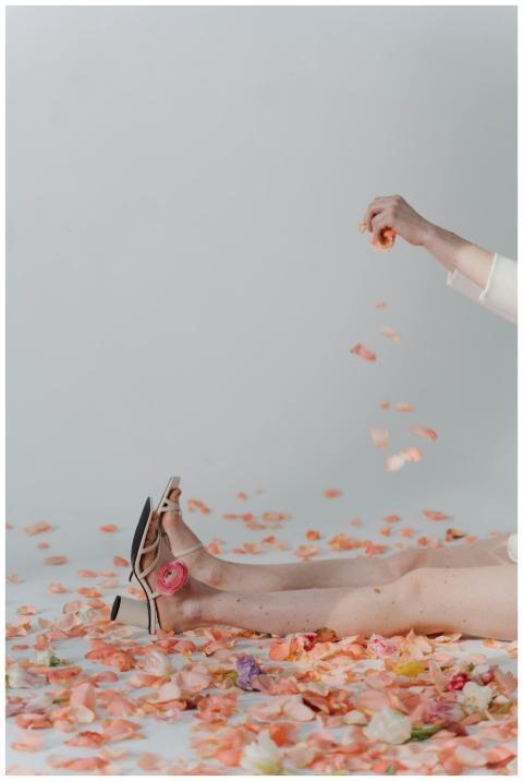 An artistic studio shot of legs in high heels surr