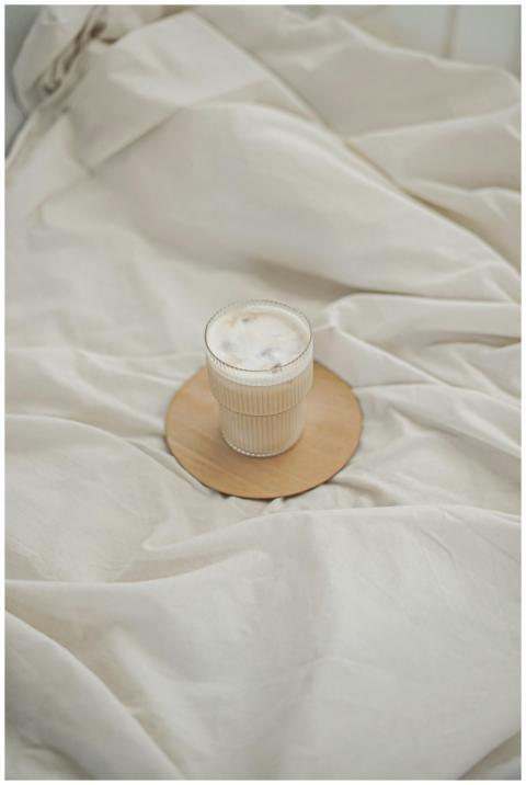 Warm coffee on elegant wooden coaster against cozy